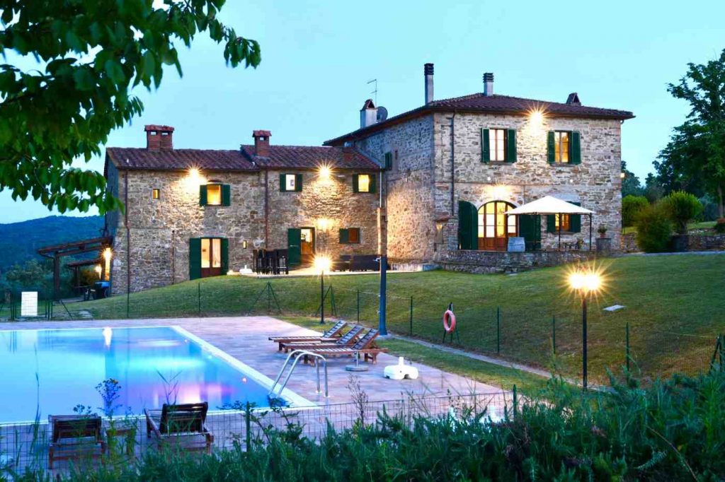 The swimming pool and terrace belonging to our rental apartments in Central Tuscany at Dusk