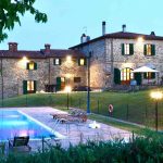 The swimming pool and terrace belonging to our rental apartments in Central Tuscany at Dusk