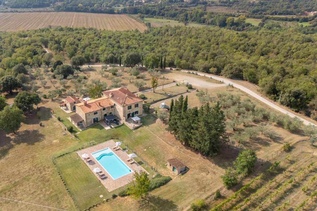 Aerial view of Agriturismo Poggilunghi in Tuscany with swimming pool, vineyard and olive groves