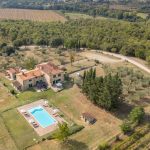 Aerial view of Agriturismo Poggilunghi in Tuscany with swimming pool, vineyard and olive groves